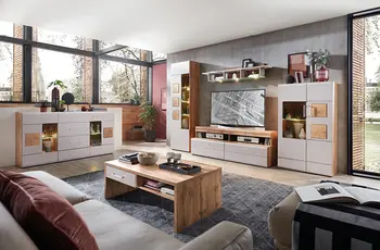 Modernes Wohnzimmer mit weißer Wohnwand in Holzoptik, TV-Möbel mittig, Sideboard links und Couchtisch auf grauem Teppich.